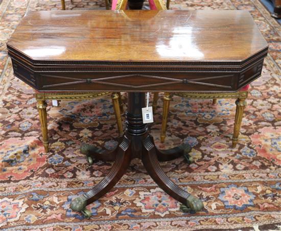 A Regency mahogany card table, with canted corners, on plain column and ring turned support with four reeded W.90cm
